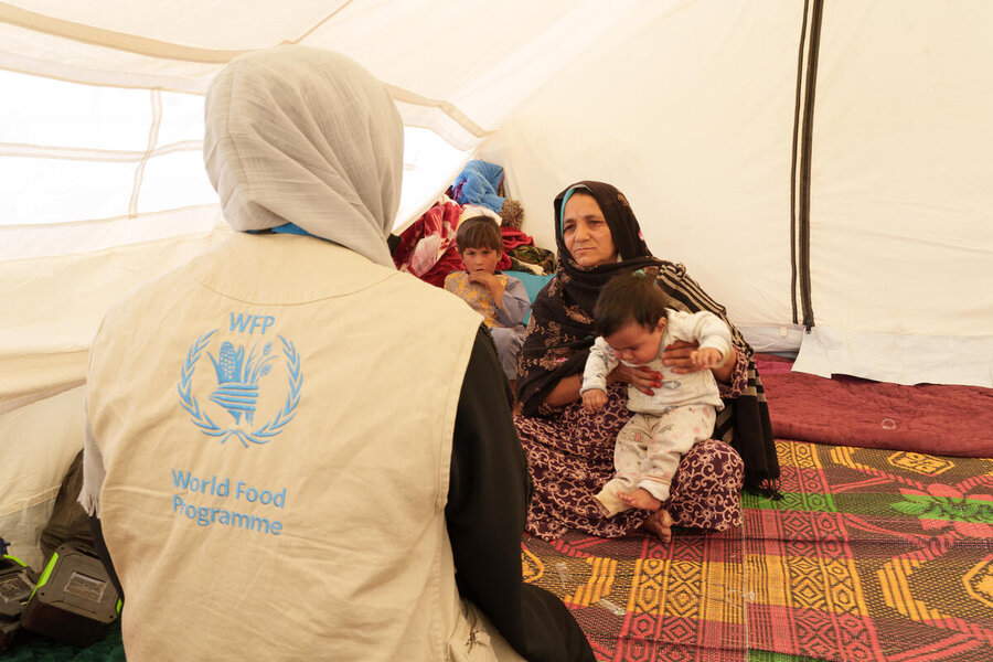 A grandmother who lost her daughter in the October earthquakes holds her grandchild. Photo: WFP/Hasib Hazinyar