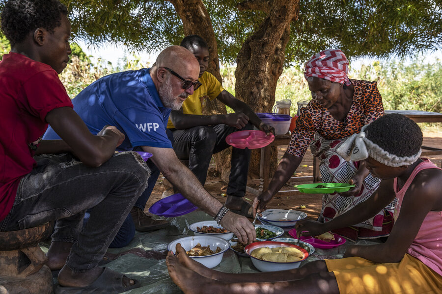 Andrew Zimmern shares a meal with Emeldah Hichoombolwa and her family in Zambia's Monze district. Photo: WFP/Gabriela Vivacqua