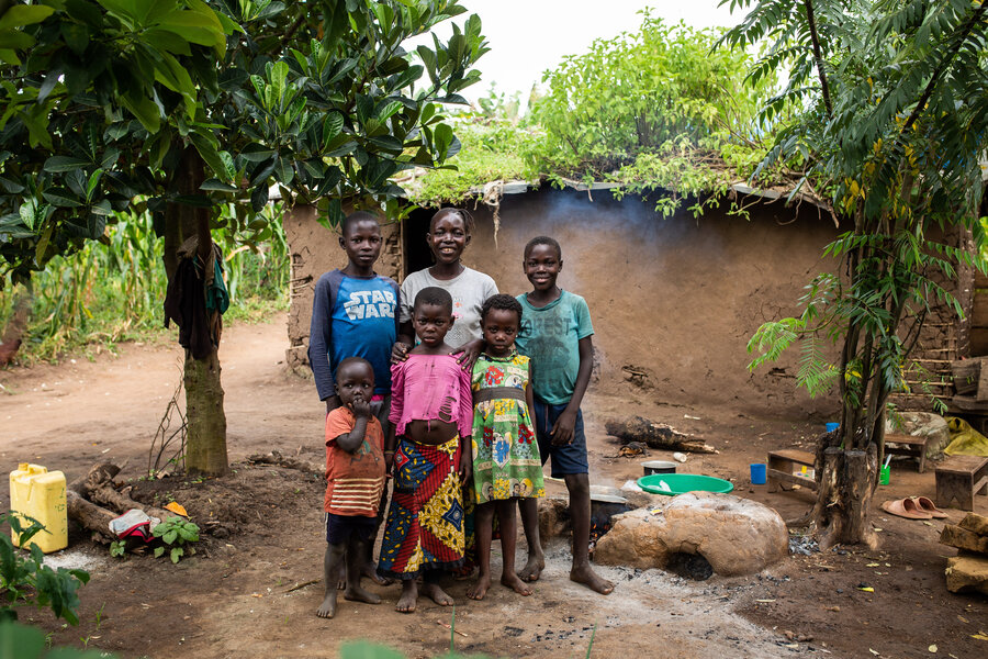Patience and her family in front of their home at the Kyangwali refugee camp.