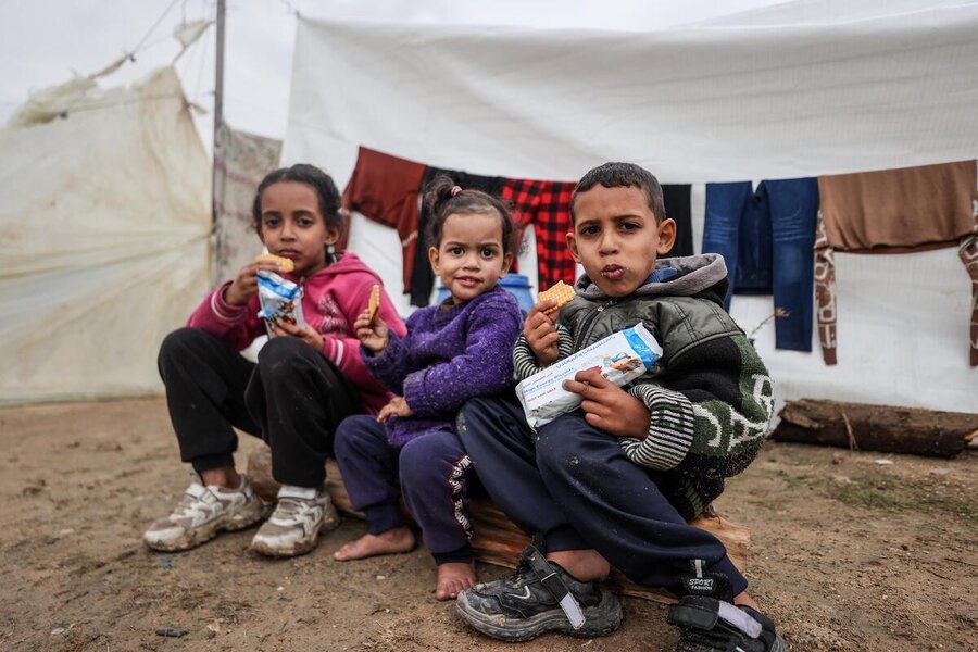 Children take fortified biscuits delivered by aWFP at a makeshift camp in southern Gaza. Photo: WFP/Ali Jadallah