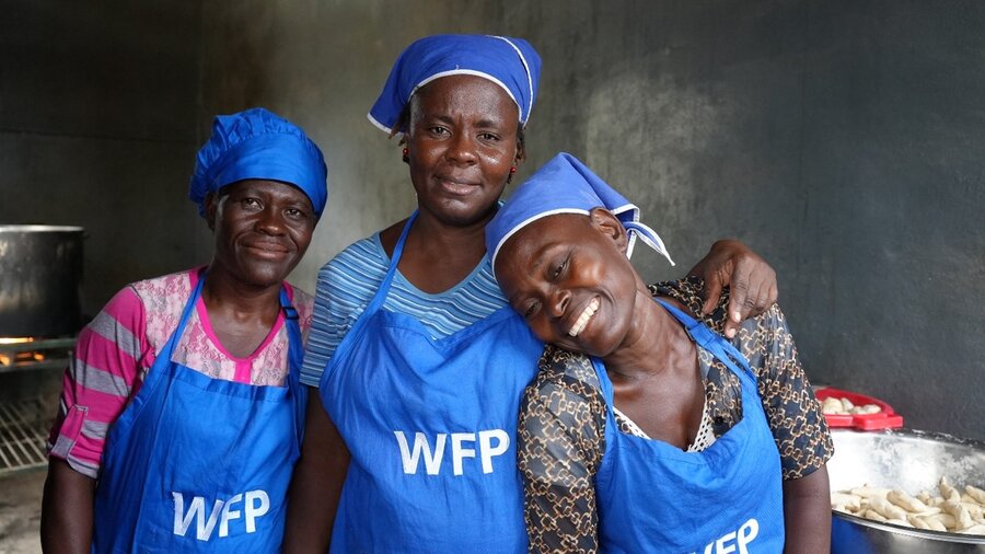 three Haitian school cooks in blue WFP aprons