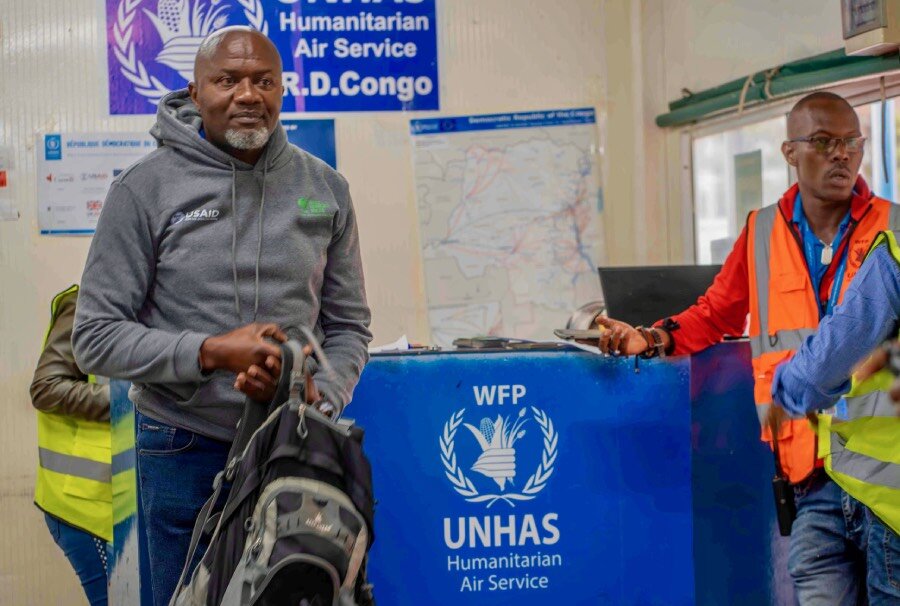 Alphonse Kizitu checks in for a UNHAS flight to Kirumba in DRC's North Kivu province-allowing him to avoid a long and dangerous land voyage. Photo: WFP/Benjamin Anguandia