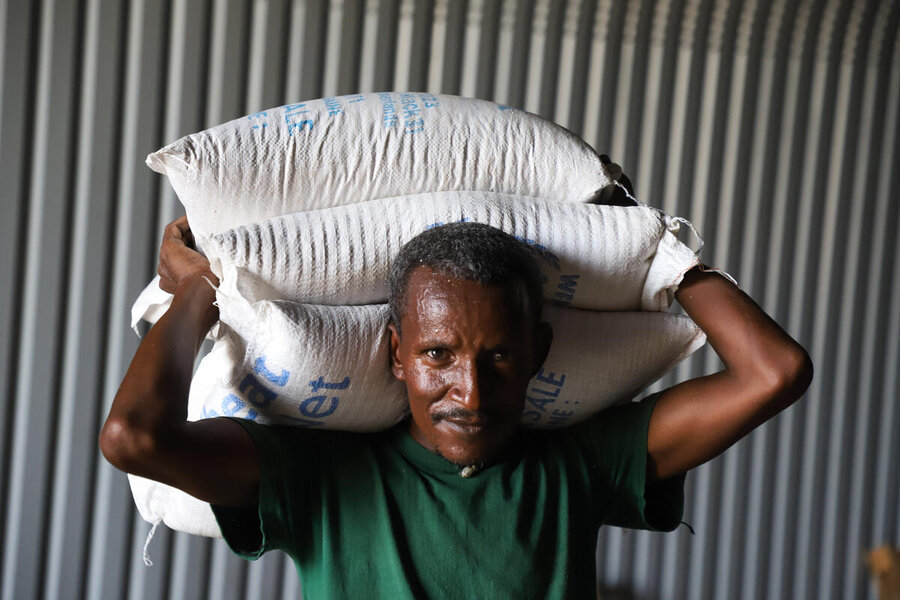 Offloading of WFP food at Hitsats IDP camp Tigray following the resumption of food aid distribution in Ethiopia Tigray region after WFP and partners set a digital controlling mechanism by digitally registering members of the community who are found to be eligible for food assistance during the vulnerability based targeting process. The Head of Household presents a QR code which is scanned by an enumerator who then takes their household data and photo and uploads it to the MODA system. Digital registration