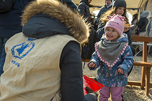 a WFP staff talking with a child