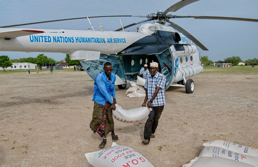 Workers unload bags of rice in eastern Kenya, hit by floods last year after years of punishing drought. Photo: WFP/Alessandro Abonizio