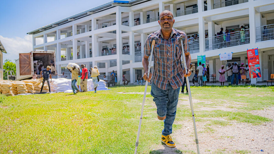 Rice grower and father of five Augustin — here receiving WFP food assistance — counts among the growing casualties of gang violence in Haiti's countryside. Photo: WFP/Luc Junior Segur 