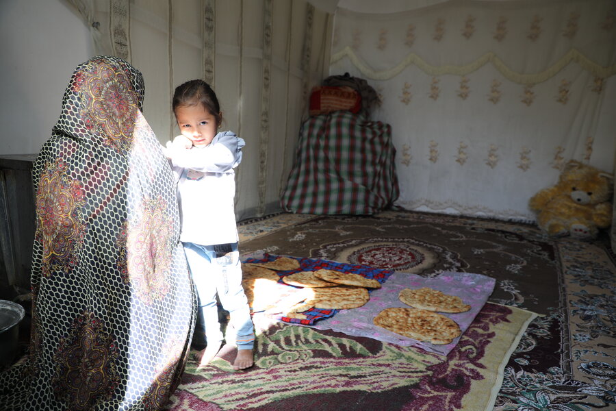 Afghan refugee Ram Bibi at home with her daughter 