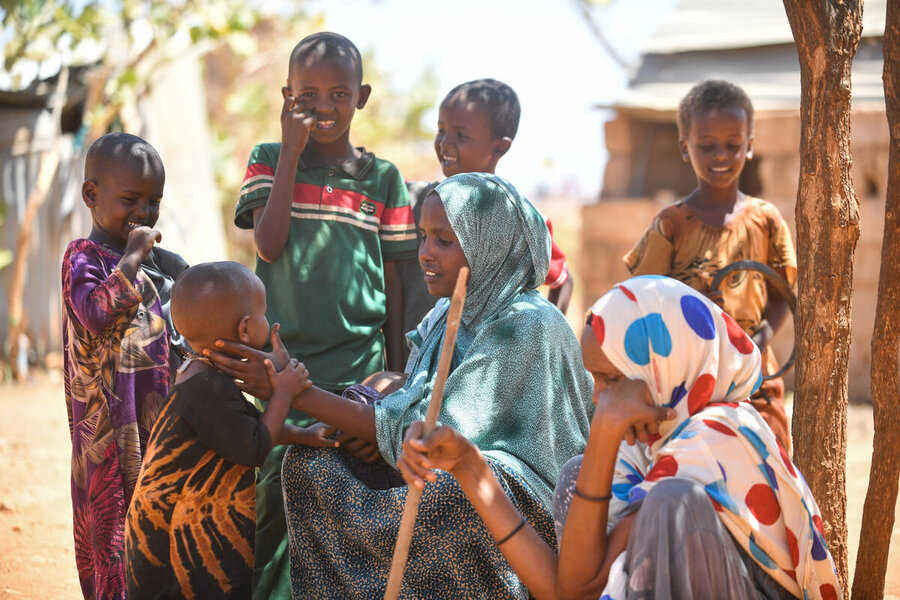 Sadiya (C) with her children. She says men at Bokolmayo first resisted the women's empowerment project; now they support it. Photo: WFP/Michael Tewelde