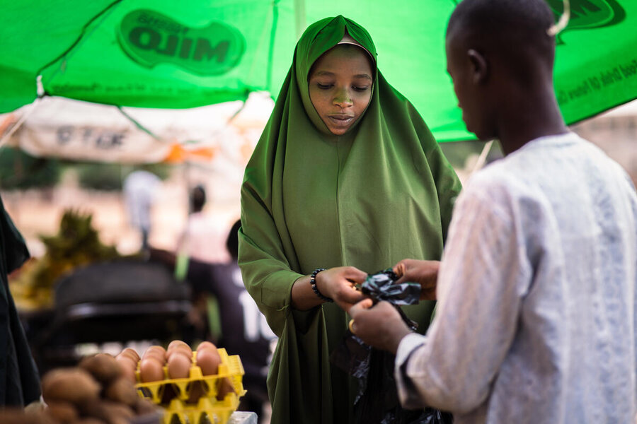 A woman buys food at a market in Katsina state. Soaring prices among other factors leading to Nigeria's spiking hunger numbers. Photo: WFP/Abdul Ozavogu