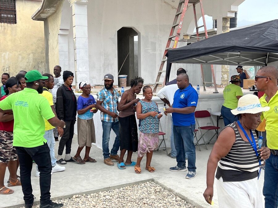 People line up at a WFP food distribution in Haiti