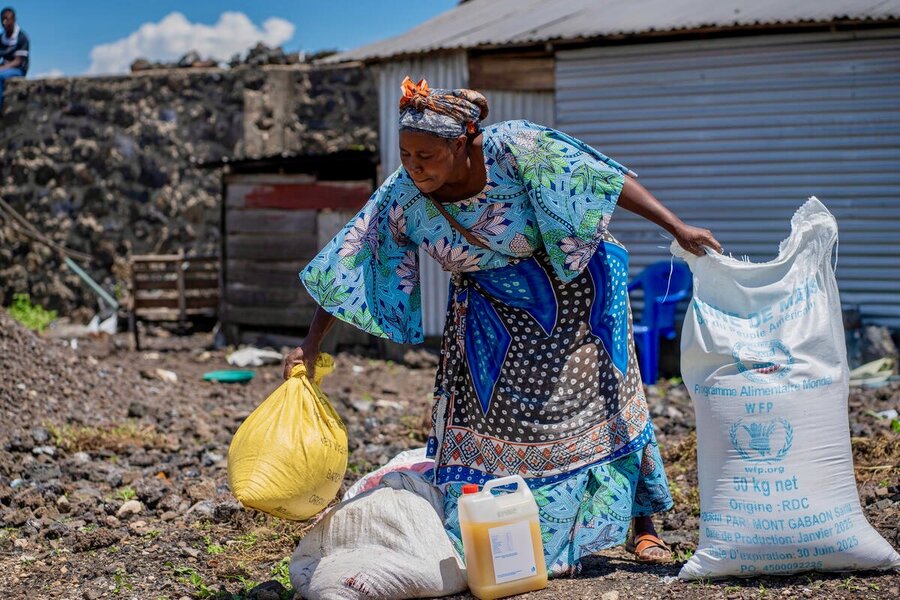 A woman collects WFP food assistance in Goma, where a precarious calm reigns after fighting earlier this year. Photo: WFP/Benjamin Anguandia