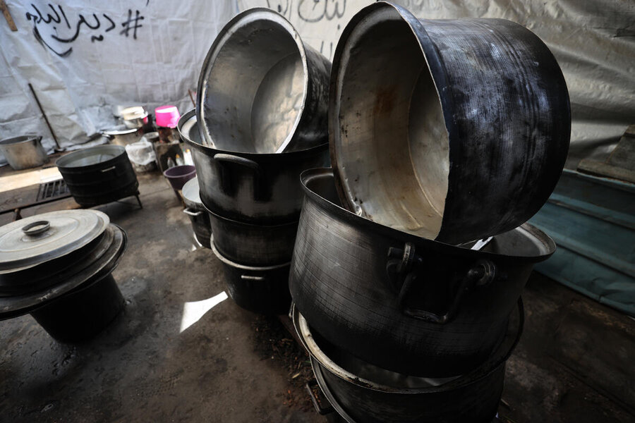 Empty coooking pots at closed hot meals point n Gaza