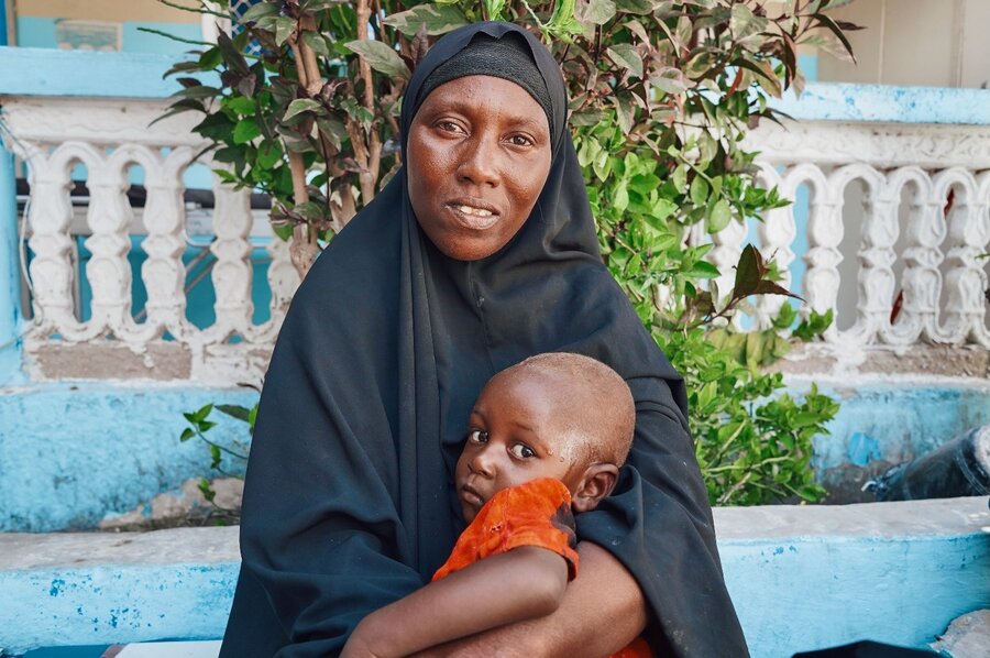 Farhia Ali holds her small daughter at she await treatment at a Mogadishu health centre. Photo: Sara Cuevas Gallardo