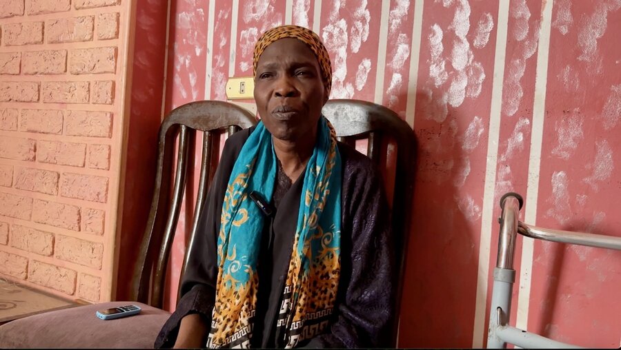 Theresa, a mother of seven - here sitting on a wooden chair in Cairo - counts among the many refugees who have lost WFP assistance. Photo: WFP/Mariam Zaki