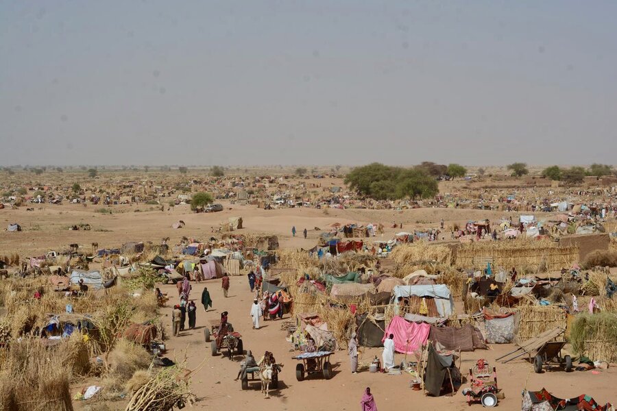 A wide view of Tawila displacement camp - makeshift cloth tents and straw thatched walls, surrounded by sand. Photo: WFP/Mohamed Galal