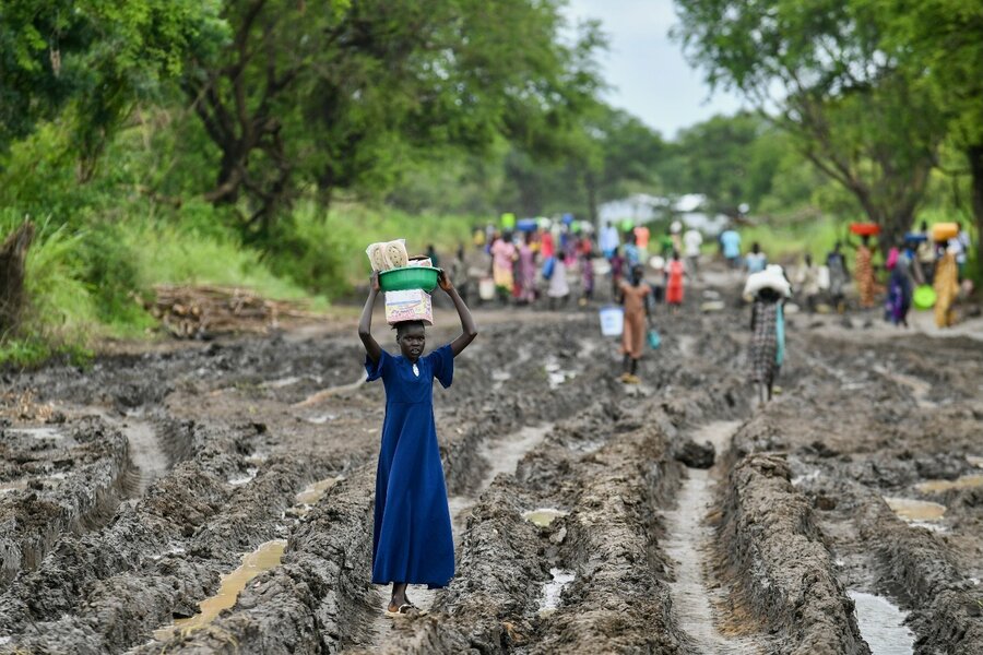 South Sudanese refugees pick through muddy roads on their way to safety in Ethiopia. Photo: WFP/Michael Tewelde