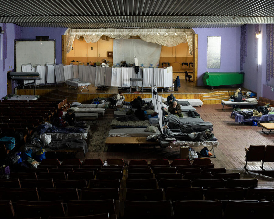 What looks like a school hall with beds in it - a transit centre in Ukraine