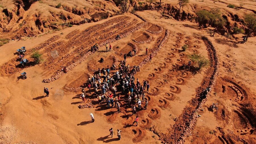 An aerial view of people gathered around a land restoration effort in Kenya. Photo: WFP/Vivid features