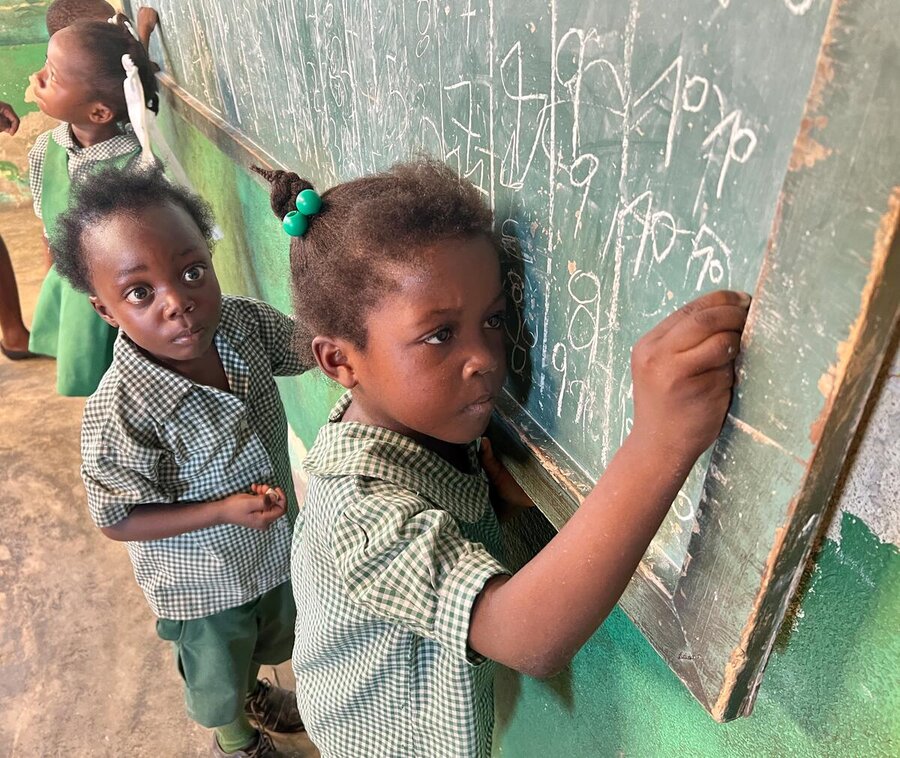 Children writing on a blackboard in Cite Soleil, Haiti. Photo: WFP/Jonathan Dumont