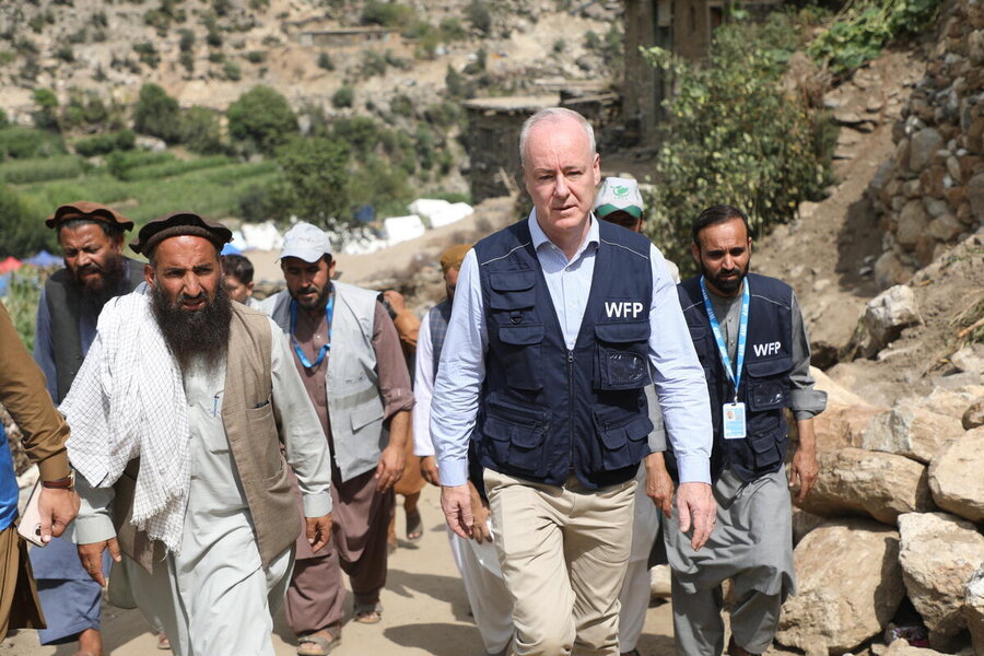 WFP's John Aylieff in a blue vest is accompanied by Afghani colleagues on a visit to a hilly area