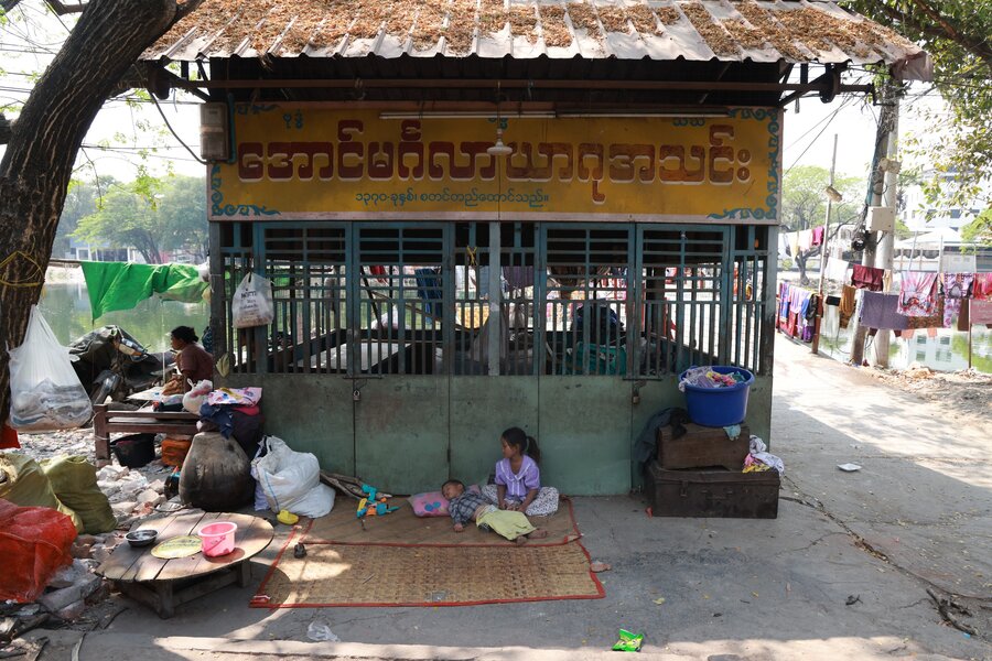 Two young children sit in a mat outside in an impoverished neighborhood outside the Myanmar's second-largest city of Mandalay, which was hard hit by last year's earthquake. Photo: WFP/Htet Oo Linn
