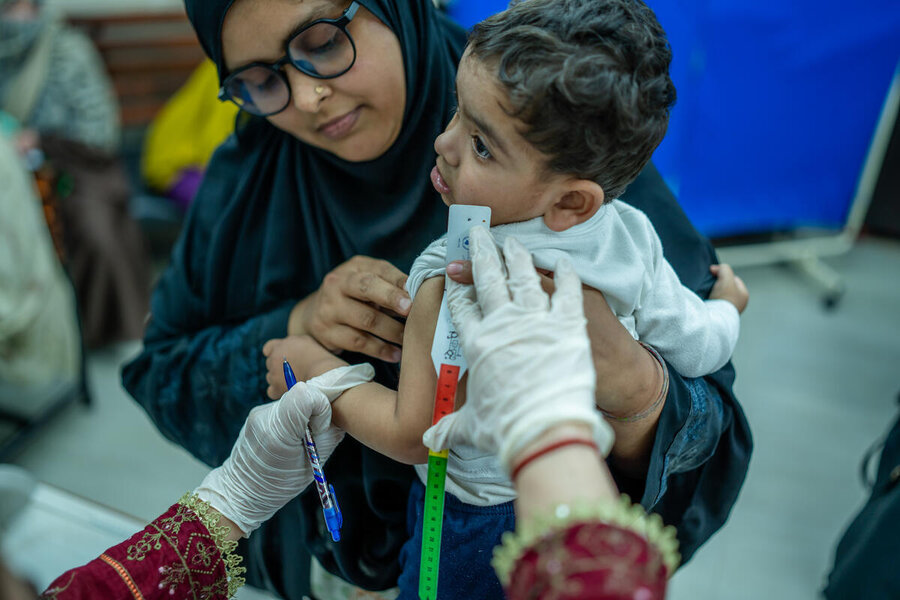 A woman holds a little boy who is being screened for malnutrition. Photo: WFP/Pakistan