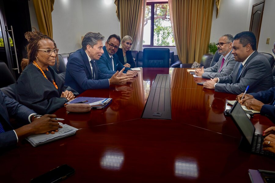 Women and men in suits sitting around a table. Photo: OCHA/Mateo Minasi