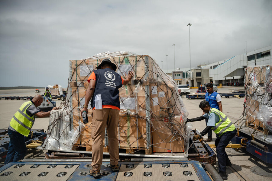 WFP workers wearing vests move cargo destined for our Venezuela earthquake response. 