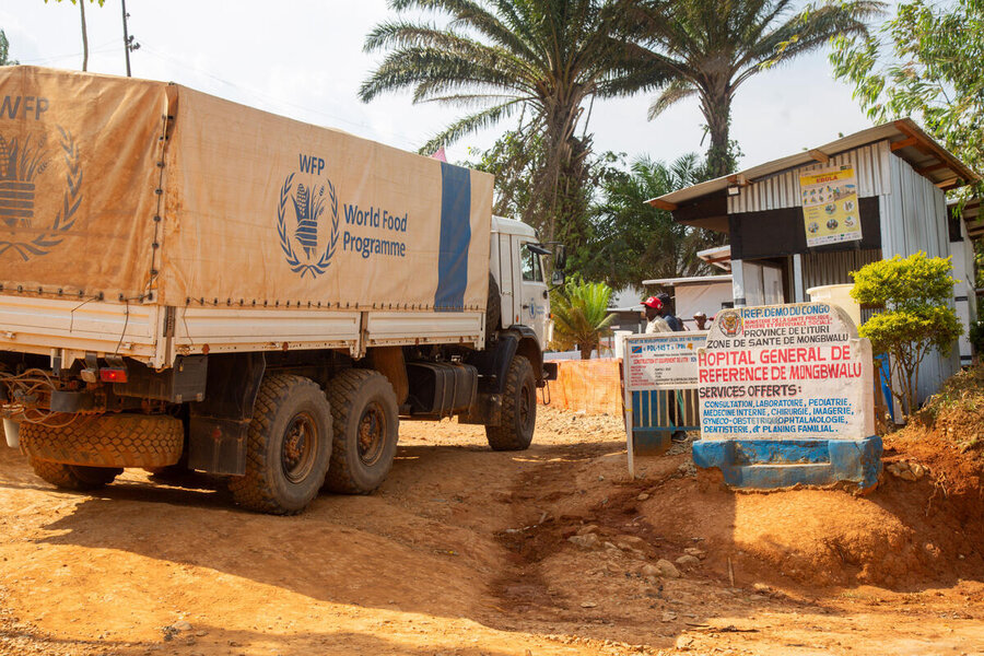 A WFP truck is parked in front of a small building with a sign that says it's a hospital in Mongbwalu, DRC. Photo: WFP/Arete/Seros Muyisa