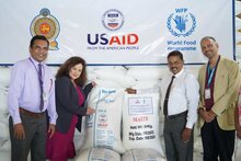 Photo: WFP/ Gallery. Asta Zimbo, USAID, hands over packs of soya & maize to Deepthi Kularathna, Chairman, Thriposha
