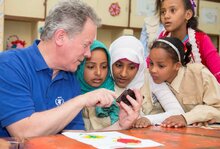 Executive Director Beasley showing images to children