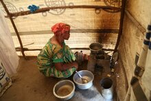 Photo: WFP/Deborah Nguyen, WFP food assistance beneficiary getting ready to prepare a meal for her family, Tanganyika, Kalemie (DRC)