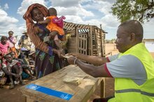 Photo: WFP/ Giulio d'Adamo, woman receiving cash at the WFP distribution site in Maheny (Beloha Region), Madagascar.