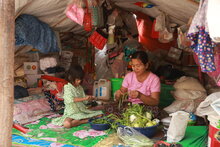 WFP/Htet Oo Linn, A displaced family sheltering at a makeshift tent in Sagaing as the March 2025 earthquake their home. The family fled armed conflict in Sagaing before the earthquake hit.