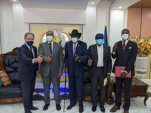 Photo: WFP/ Photogallery, Executive Director David Beasley with Sudanese government representatives and rebel leaders. 