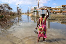 Photo: WFP/Alexis Masciarelli, a woman returns to her house carrying a box of WFP emergency food on her head, after a distribution in support of the emergency response of the government of Jamaica in the area of Arlington, St Elizabeth parish, one of the most damaged by Hurricane Melissa.