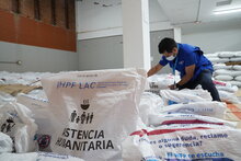 A WFP staff member prepares food baskets for distribution to households affected by the earthquake