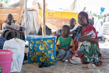 Photo: WFP/Julian Frank. Newly arrived IDPs wating in the shade, Mozambique, Cabo Delgado.