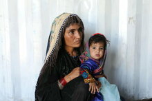 WFP/Marco Di Lauro Woman and her child at a nutrition clinic run by WFP and UNICEF near an IDP camp on the outskirt of Herat.