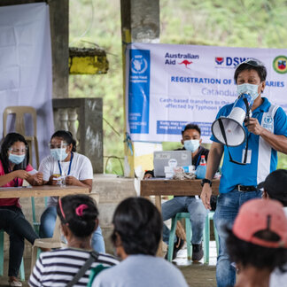 a WFP staff is giving a speech in front of a crowd