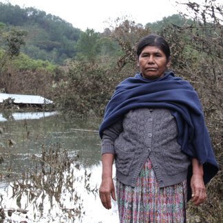 a woman is standing next to a river