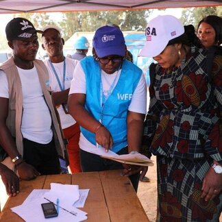 A WFP staffer showing other people a chart