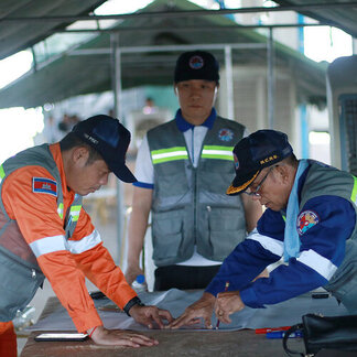 CAM SAR team member is monitoring on the map to study about the crisis disaster in the community during the stimulation workshop in Benteay Meanchey province.