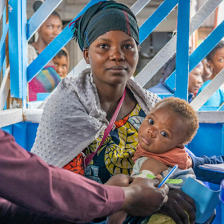 A mother and baby attend a health centre established as part of  scale-Up efforts in Eastern DRC 