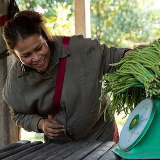 Mec Sinat (36), poses for a photograph. Sinat currently is the supplier of vegetables to Bos Thom school in her village near Siem Reap.