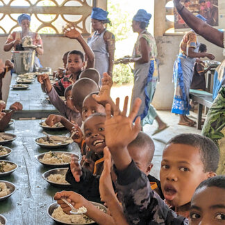 Children are having their meals in their school