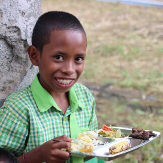 a school boy is having his meal