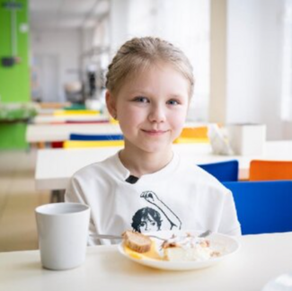 Child eating healthy and nutritious school meals
