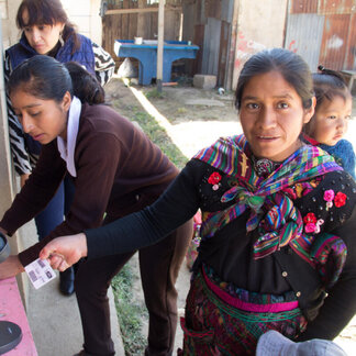 Silvia Petrona Vicente scans her SCOPE card at a WFP distribution post in San Vicente Buenabaj, province of Totonicapan. 
