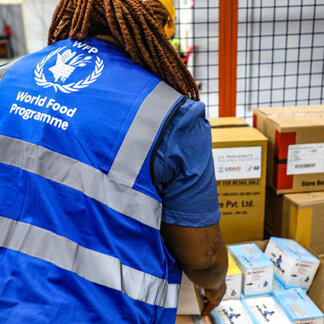 WFP and security staff from the Central Medical Store load the lorry used to transport medicines for the treatment of HIV/AIDS and sexually transmitted infections to Benson Hospital in Monrovia.